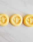 all natural bee lotion bars, made with beeswax, honey, lemon, and lavender scented.
