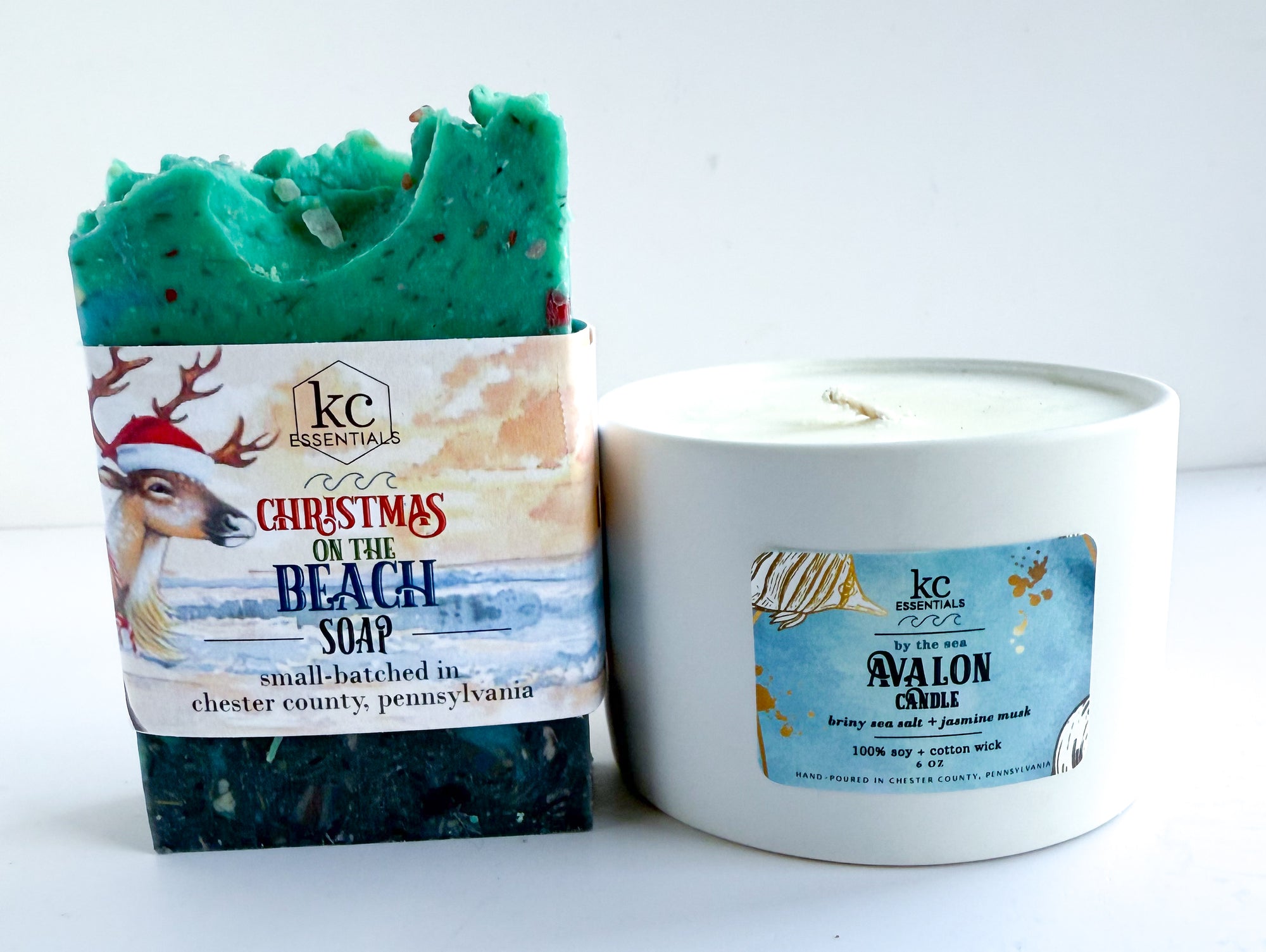Bar of soap with a Christmas design and a candle labeled 'Avalon Candle' on a white background. Christmas on the Beach soap, avalon new jersey, jersey shore, beach, beach scented, christmas gift ideas, holidays, festive