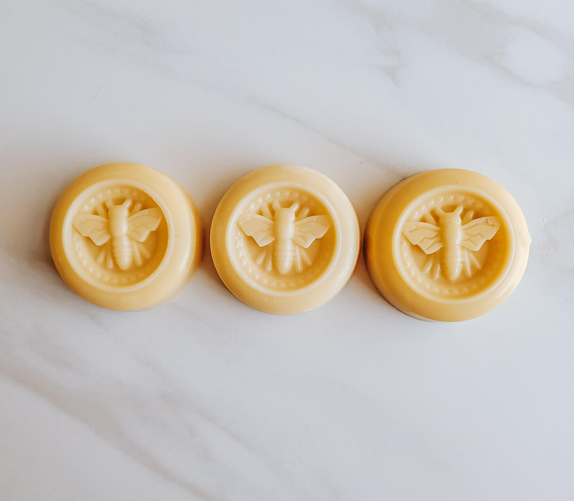 Bee lotion bar, available in three scents: lemon, lavender, honey.