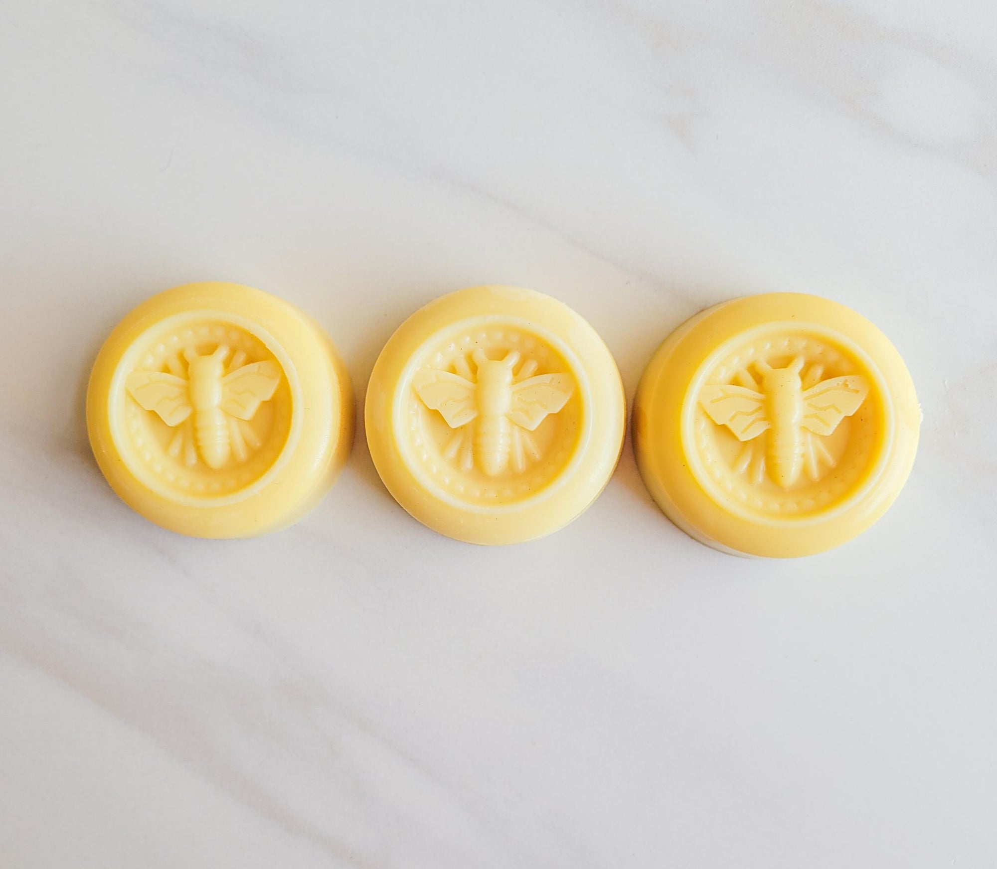 all natural bee lotion bars, made with beeswax, honey, lemon, and lavender scented.