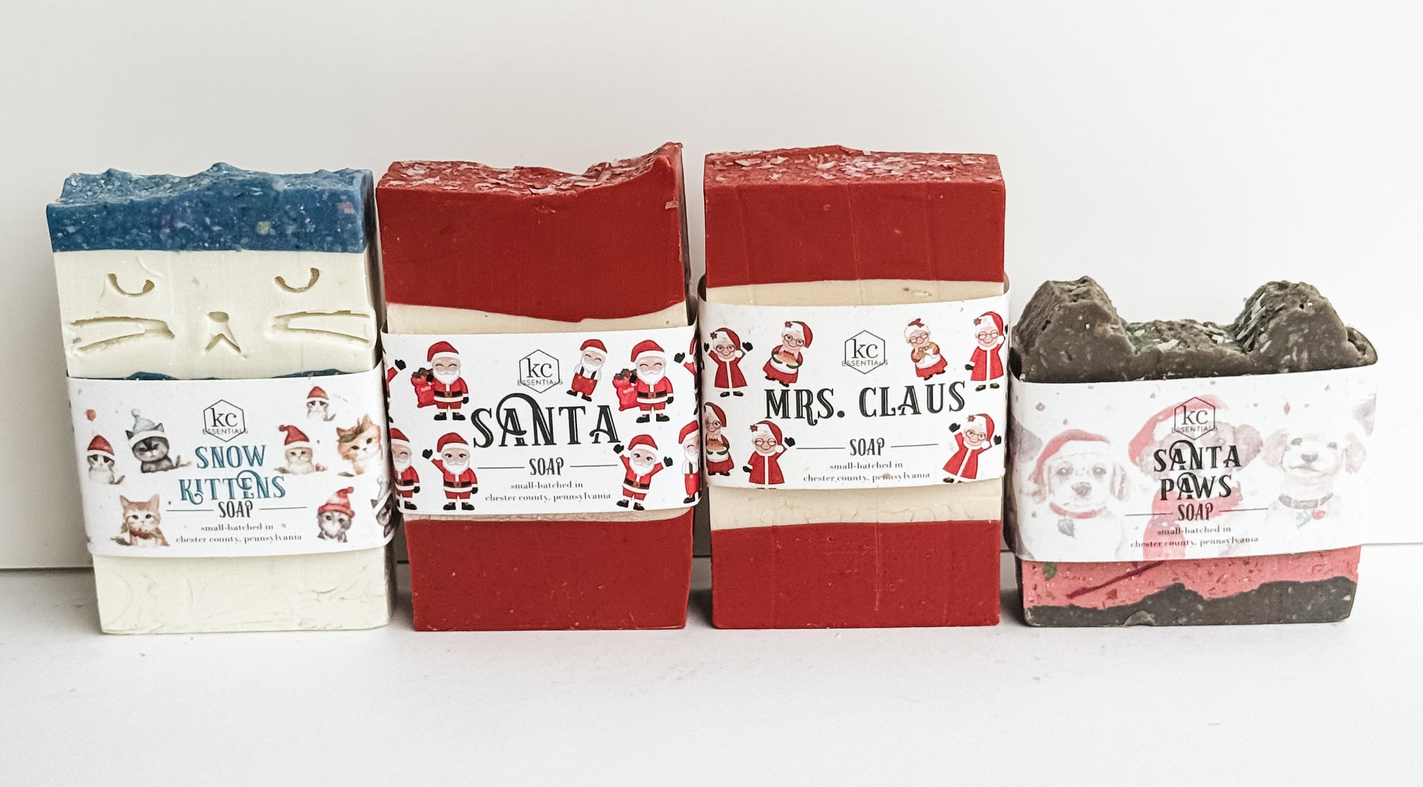 Christmas handcrafted soap bar gift set includes snow kittens, santa, mrs. claus, and santa paws soaps. Approximately 5.5 ounces each.