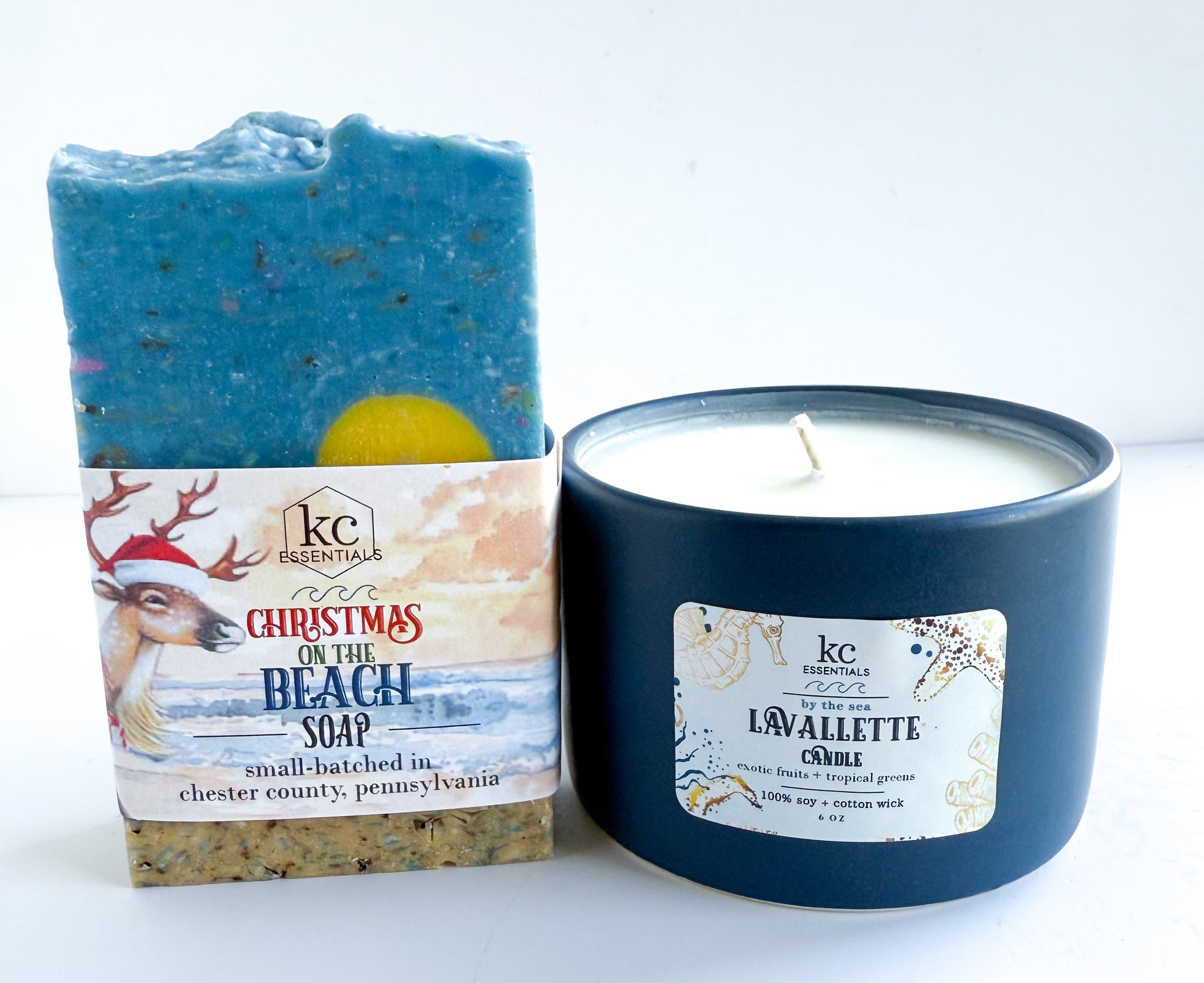 Blue soap bar with 'Christmas on the Beach' label and blue candle with 'Lavallette' label on a white background, Christmas on the beach soap, handcrafted soap bar, all natural ingredients, lavallette beach, 100% soy candle, christmas gift ideas, holidays, festive