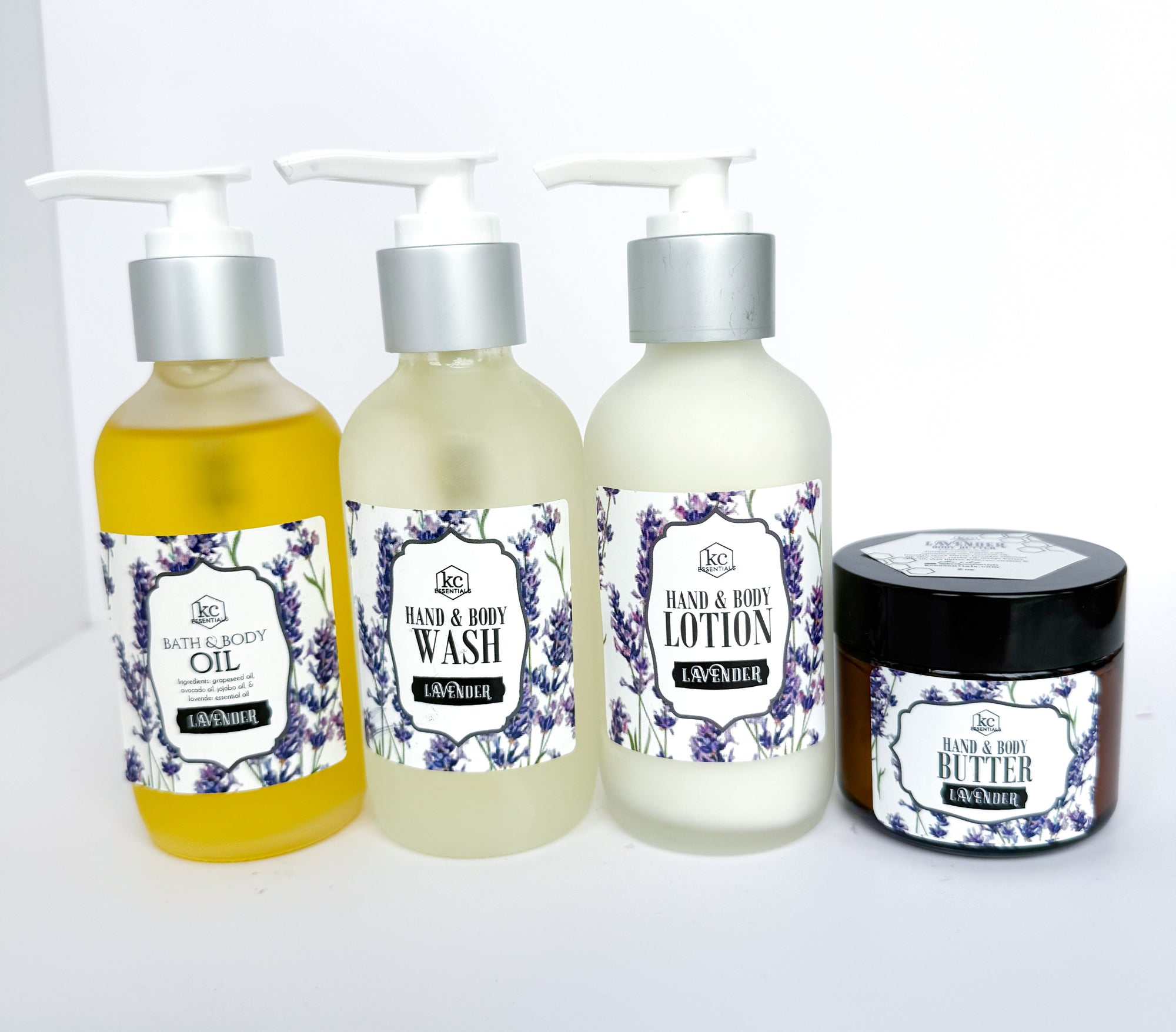 Set of lavender-themed skincare products including oil, wash, lotion, and butter on a white background.