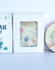 handcrafted loofah soap bar, packaged in a cardboard box, white color, unscented.