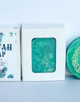 handcrafted loofah soap bar, packaged in a cardboard box, green color, unscented.