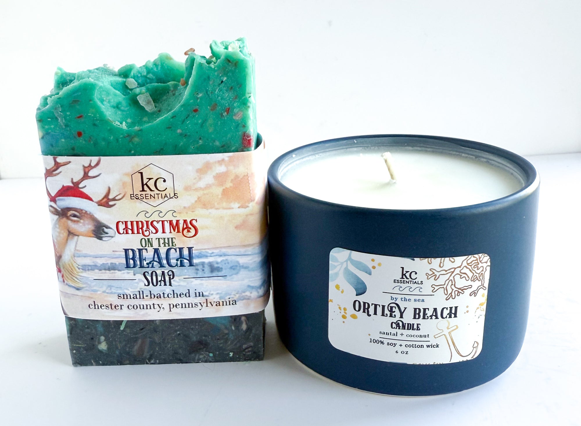 Soap bar and candle with 'Christmas on the Beach' branding on a white background. Navy ceramic vessel, ortley beach, beaches, beach scented, christmas gift ideas, holidays, festive, all natural ingredients, handcrafted soap bar