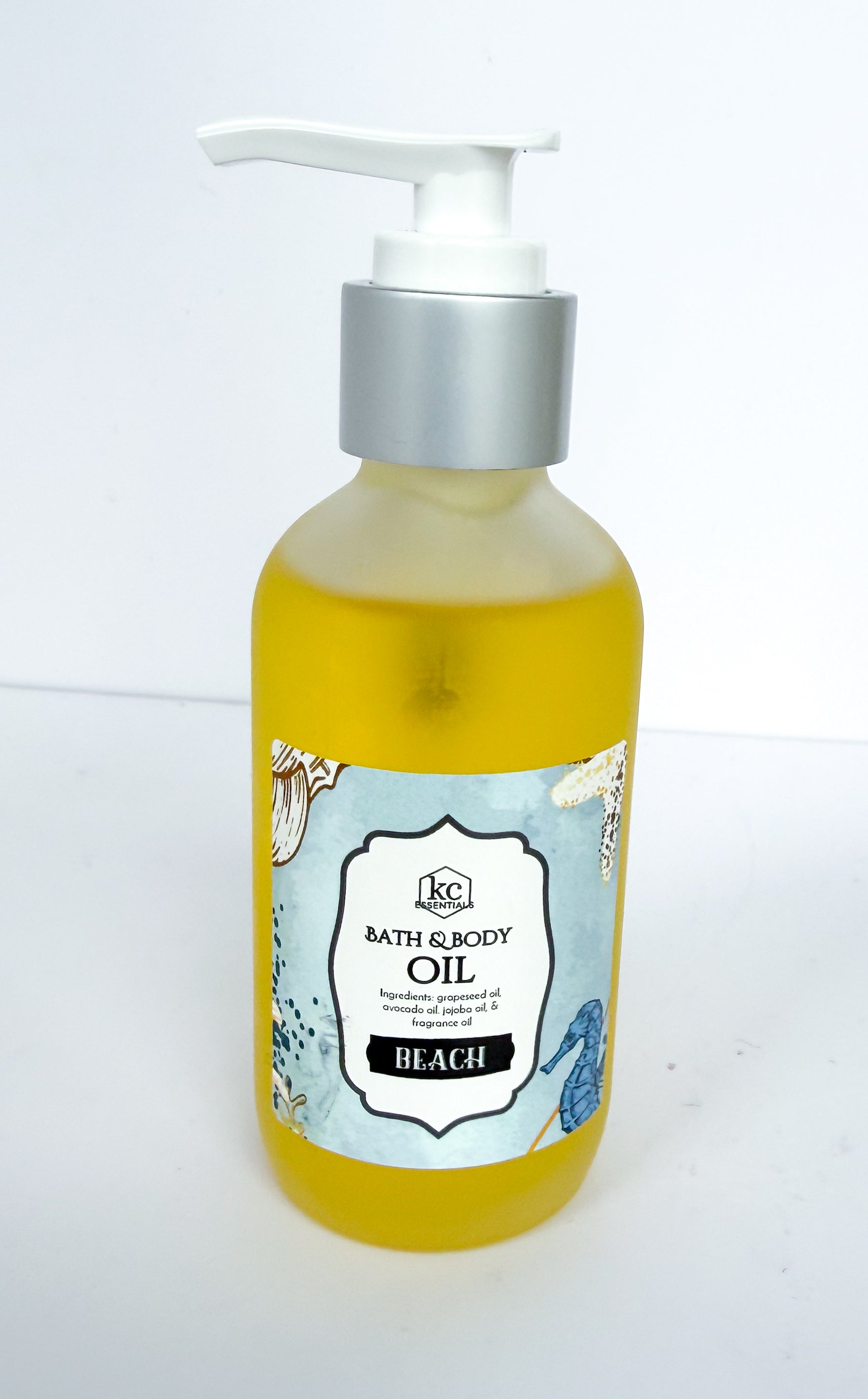 Bottle of bath and body oil with beach scent on a white background, made with all natural oils and essential oils for scent